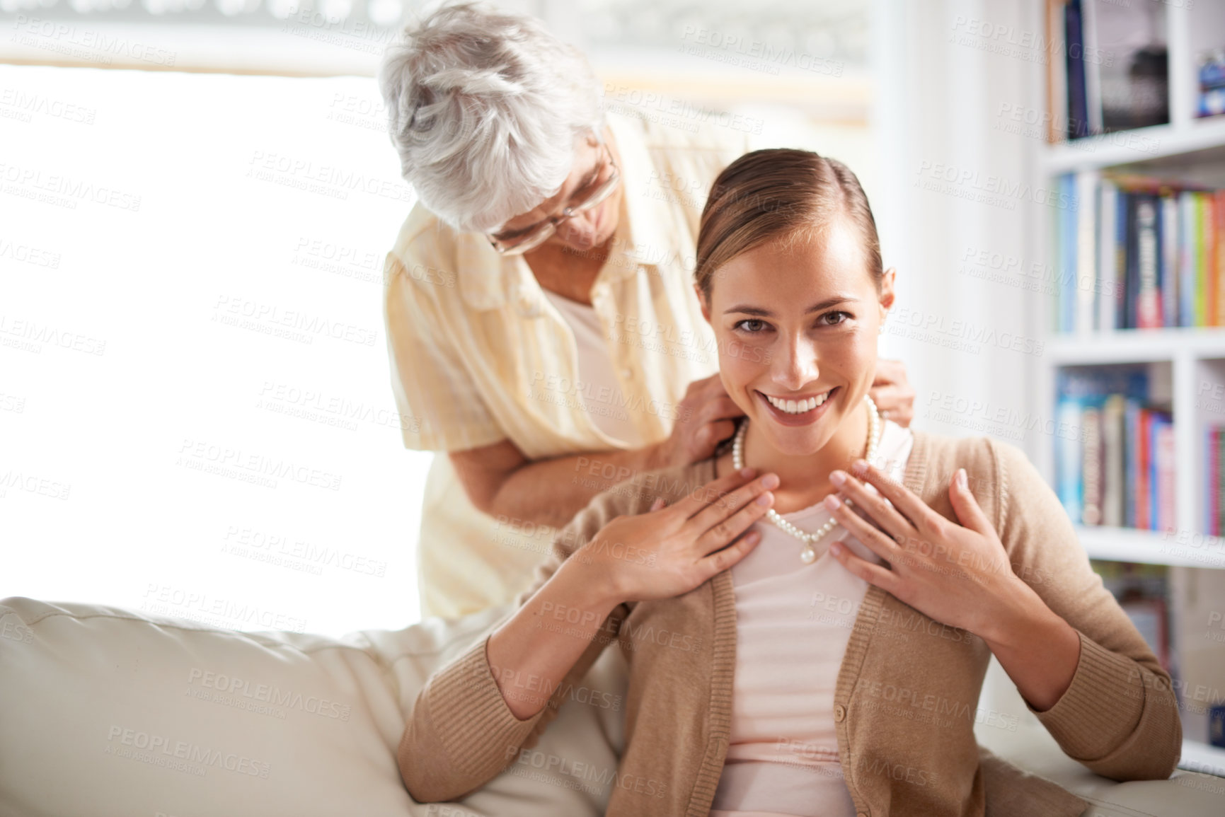 Buy stock photo Portrait, necklace and senior mother with woman for present, gift and surprise in living room. Family, love and happy daughter with mom giving pearls on sofa for celebration, birthday and bonding