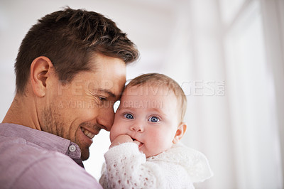 Buy stock photo Shot of a young father holding his adorable baby girl