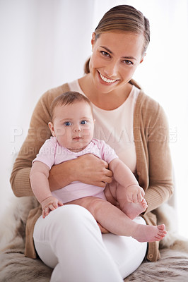 Buy stock photo Shot of a young mother bonding with her baby girl