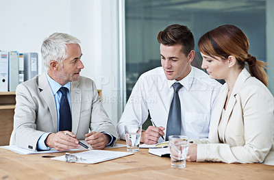 Buy stock photo Shot of a group of colleagues having a meeting in the boardroom 