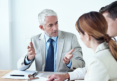 Buy stock photo Shot of a group of colleagues having a meeting in the boardroom 