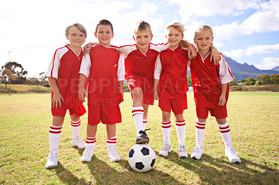 Buy stock photo Children, group portrait and soccer team on grass, happy and collaboration or support. People, kids and ready for match and partnership or teamwork, smiling and solidarity or energy for game or match