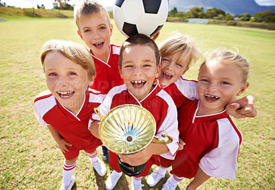 Buy stock photo Celebration, soccer team and children with cup, boys and girls with victory, support or proud. Achievement, sports and friendship, together and happy for win, ready for game or physical activity
