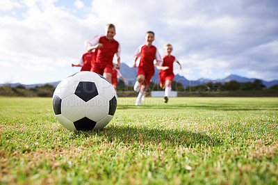 Buy stock photo Running, teamwork and sports with children and soccer ball on field for training, competition and fitness. Game, summer and action with football player and kick on pitch for goals, energy and athlete