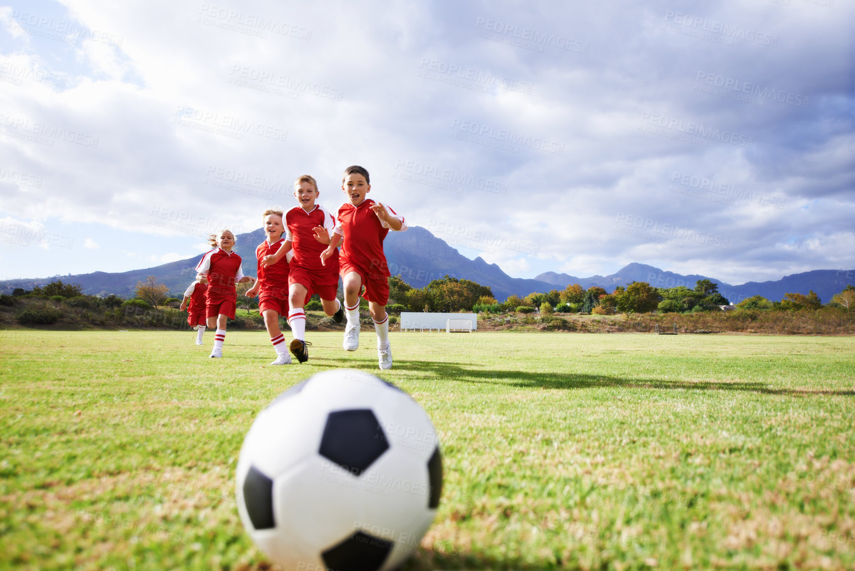 Buy stock photo Running, fitness and sports with children and soccer ball on field for training, competition and teamwork mockup. Game, summer and action with football player on pitch for goals, energy and kids