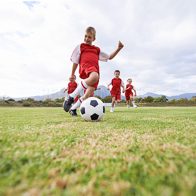 Buy stock photo Running, kick and sports with children and soccer ball on field for training, competition and fitness. Game, summer and action with football player on pitch for goals, energy and athlete