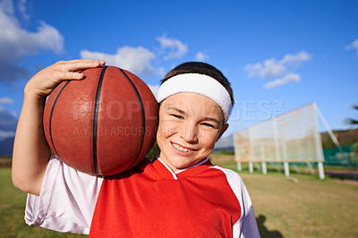 Buy stock photo Happy girl, portrait and basketball on green grass for outdoor match or fun game in nature. Face of young female person, kid or sports player smile with ball on field and cloudy blue sky for exercise