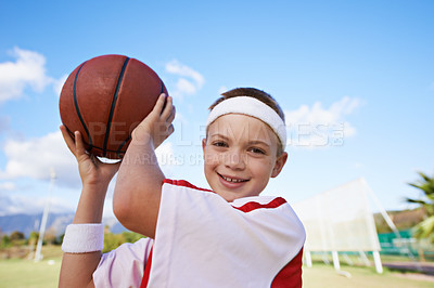 Buy stock photo Happy girl, portrait and basketball on field for outdoor match or fun game in nature. Face of young female person, kid or sports player smile with ball on green grass and cloudy blue sky for exercise