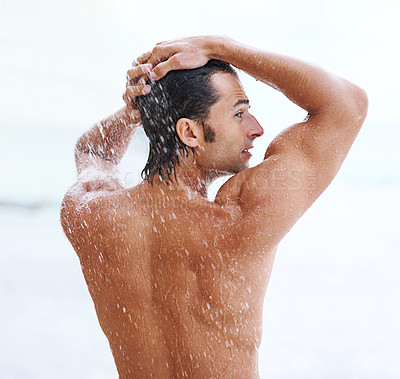 Buy stock photo Shower, beach and man with water for cleaning, washing and grooming for healthy skin. Nature, treatment and back of person with splash for natural hygiene, wellness and skincare hydration outdoors