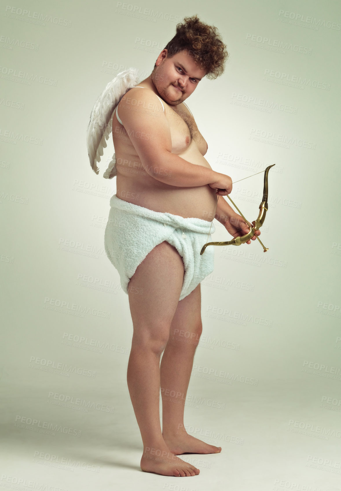 Buy stock photo An obese man dressed as a cherub with a bow and arrow