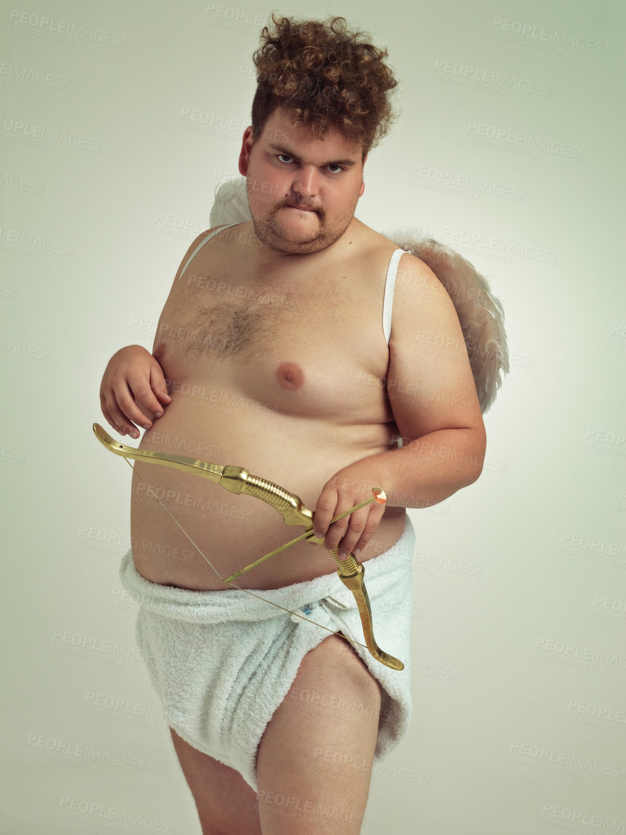 Buy stock photo Cupid, love and portrait of man with costume in studio for wings, bow and arrow on isolated gray background. Character, comic and plus size male model for fantasy, creative dress up or cosplay