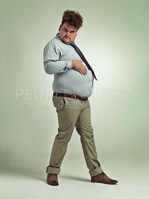 Buy stock photo Business man, portrait and plus size with stomach gesture and silly in a studio with funny joke. Goofy, employee and office fashion with fun and work clothing with green background and humor