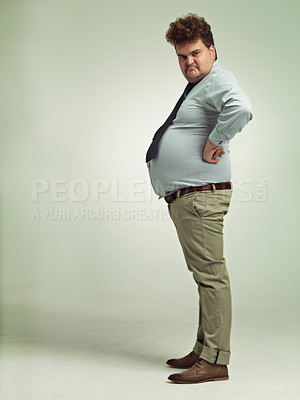 Buy stock photo Business man, portrait and plus size with grumpy, joke and silly in a studio with arms on hips. Goofy, employee and office fashion with comedy and clothing with green background and funny humor
