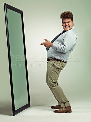 Buy stock photo Mirror, portrait and man with happiness for pointing, excited and smile for reflection in studio. Adult, plus size and male person with comic, guy and positive to change unhealthy diet and life