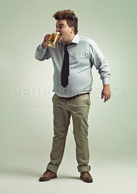 Buy stock photo Man, face and drinking with beer for party or chug in obesity on a studio background. Young male person or plus size model with glass, mug or alcohol in satisfaction for brew or booze on mockup space