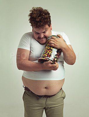 Buy stock photo Candy, jar and crazy plus size man in studio for snacks, sweets and dessert in container. Comic, funny and isolated silly person with glass for unhealthy diet, sugar and treats on white background