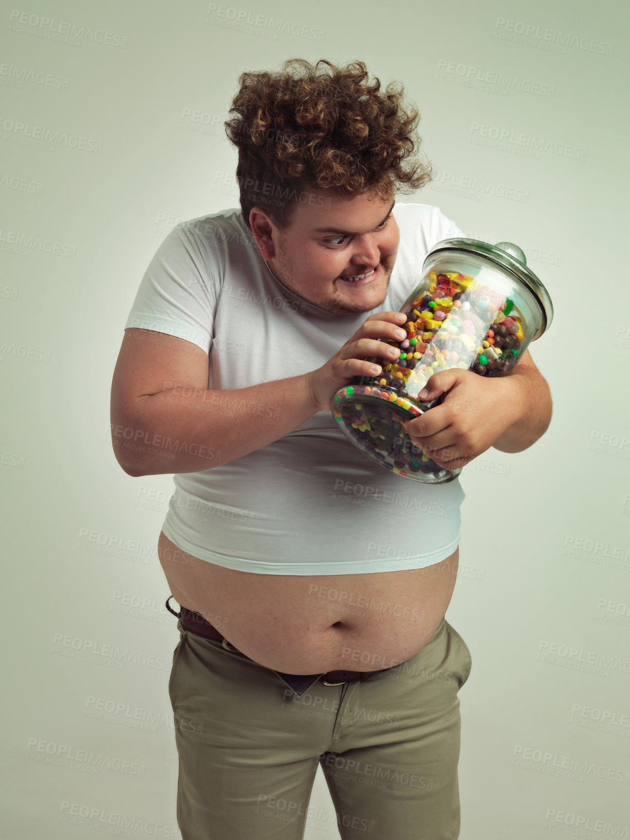 Buy stock photo Candy, crazy and plus size man on a white background for snacks, sweets and dessert in container. Comic, funny and isolated overweight person with glass jar for unhealthy diet or sugar in studio