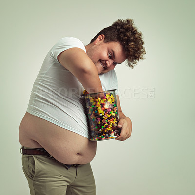 Buy stock photo Candy, jar and crazy man in studio for luxury snacks, sweets and dessert in jar. Comic, facial expression and overweight, isolated and plus size person with glass for unhealthy diet on background