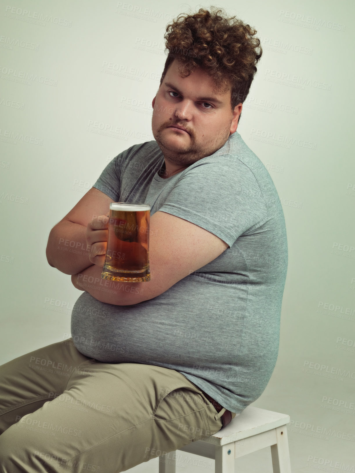 Buy stock photo Portrait, arms crossed and plus size man with alcohol for unhealthy habit, serious and weight gain in studio of white background. Face, beer and male person by drink for stomach, calories and carbs