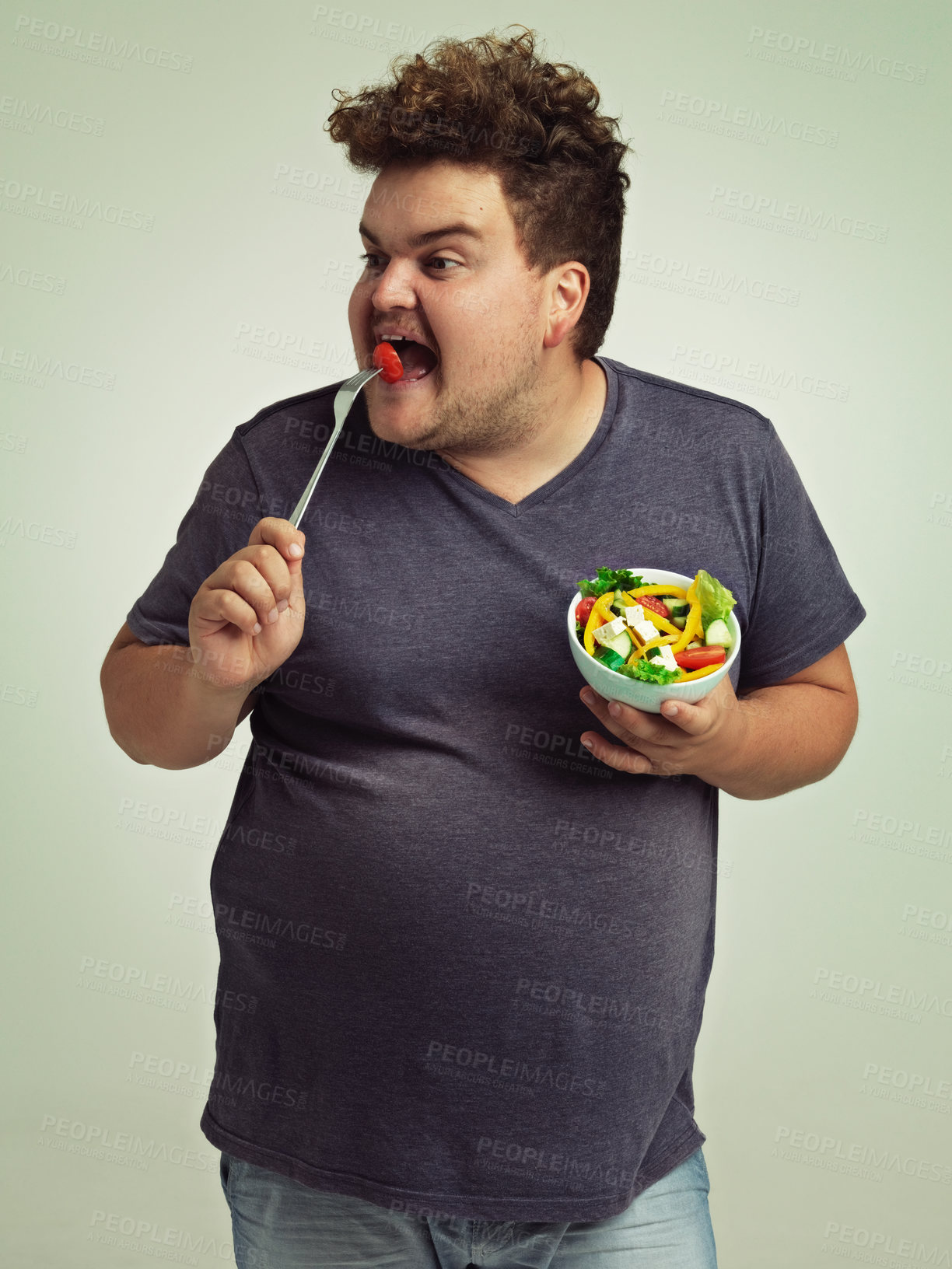 Buy stock photo Studio, plus size and man with eating salad for weight loss, healthy diet and vitamin c benefits. Fork, tomato and male person with organic food for detox, nutrition or commitment to lifestyle change