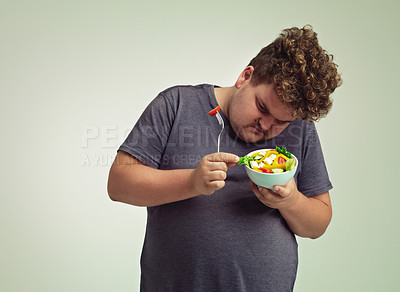Buy stock photo Bowl, man and thinking with salad in studio for healthy diet, weight loss and examine food. Plus size, male person and contemplating with organic meal for detox, lifestyle change and nutrition