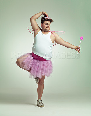 Buy stock photo An overweight man comically dressed-up in a pink fairy costume doing ballet