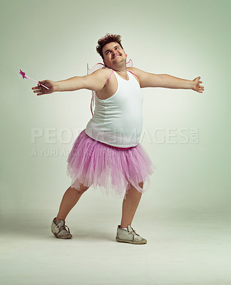 Buy stock photo Fairy, man and studio for magic and isolated, happy male person with wings and pretend costume. Pink Cosplay, fun and plus size model, dress up or play on white background for halloween on backdrop