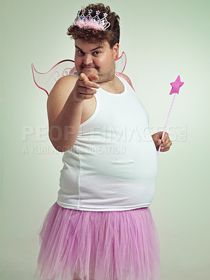 Buy stock photo Funny, man and portrait in studio as fairy with magic, wand and wings for plus size cosplay. Fantasy, character and model pointing at you in dress up for role play on white background or mockup space