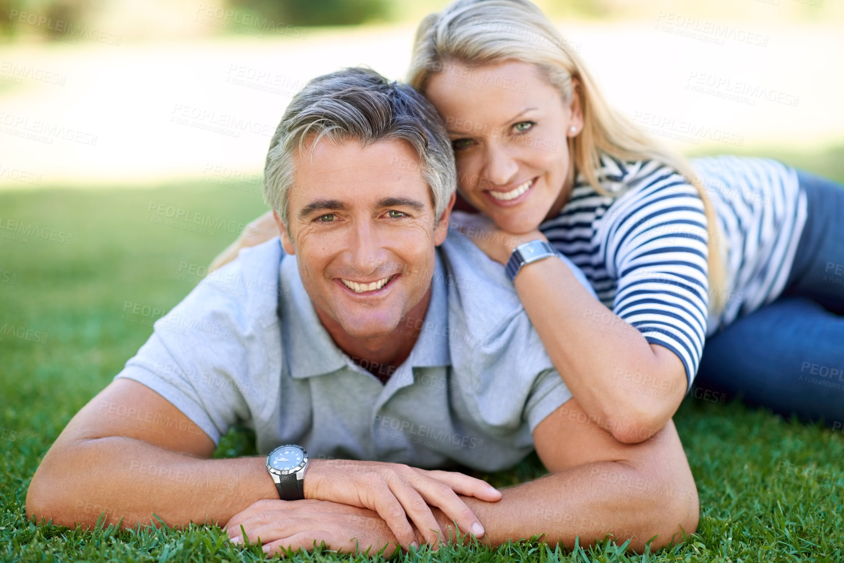 Buy stock photo Portrait, smile and couple relax on grass outdoor on date at park for love, care or support. Face, happy man and mature woman at garden for relationship, bonding together or connection with partner