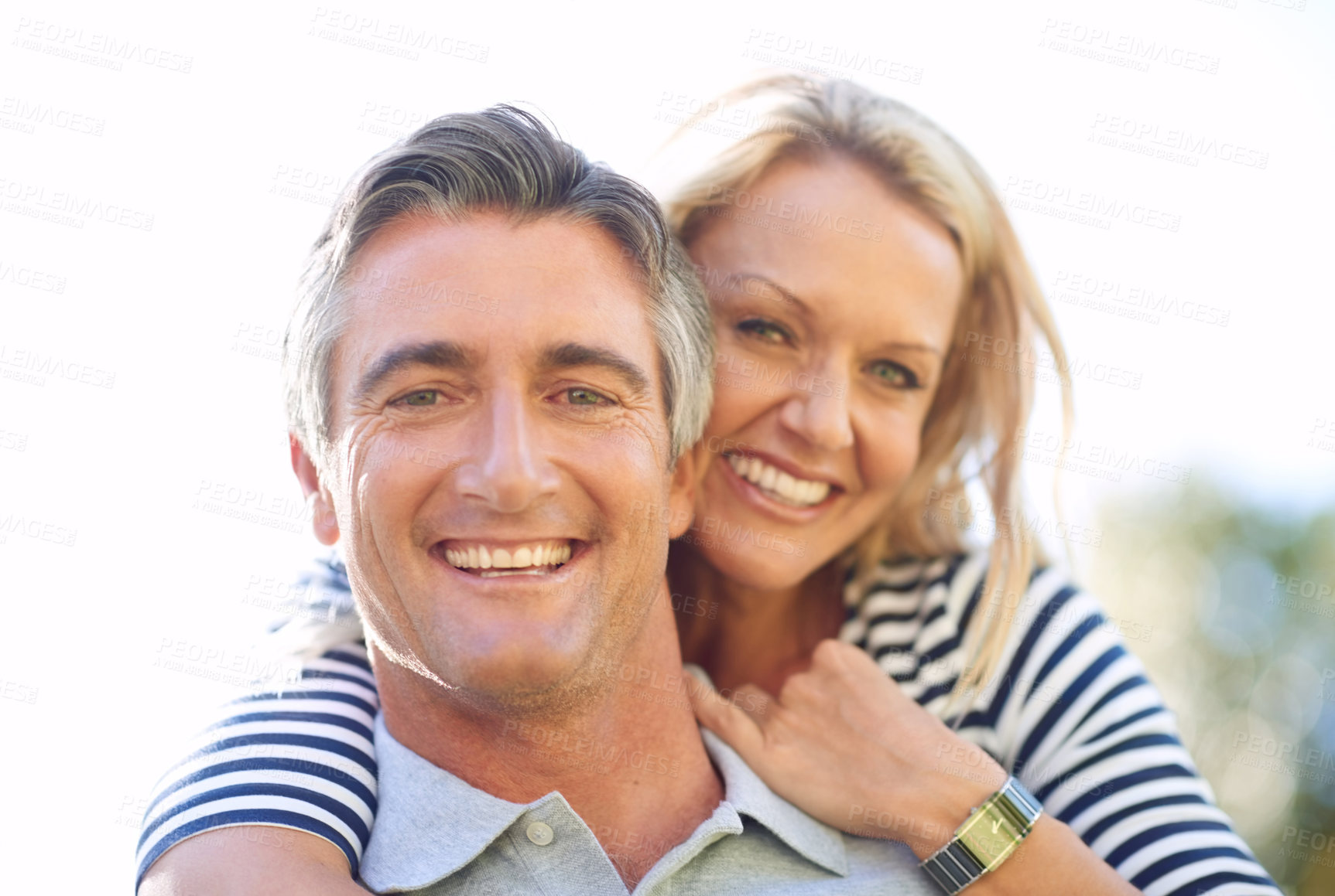 Buy stock photo Cropped portrait of a handsome mature man piggybacking his wife in the park