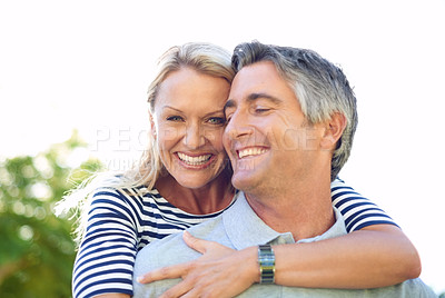 Buy stock photo Cropped portrait of an attractive mature woman on her husband's back in the park