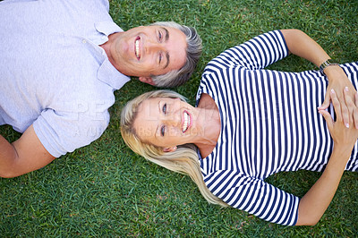 Buy stock photo High angle portrait of a mature couple lying in the park