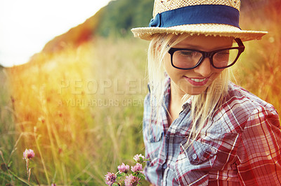 Buy stock photo Lens flare, summer and woman with flowers in field for freedom, wellness and fresh air outdoors. Nature, countryside and happy female person in natural meadow for relaxing, calm and peace in morning