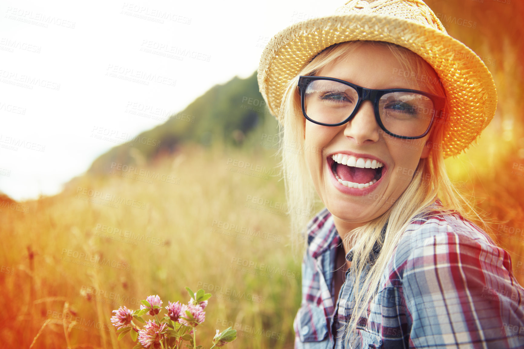 Buy stock photo Happy, countryside and face of woman laugh in field for freedom, wellness and fresh air outdoor. Nature, hipster and portrait of person in meadow with lens flare for relaxing and sustainability