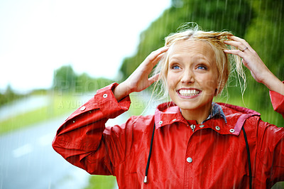 Buy stock photo Woman, smile and raincoat or hands in storm, wet and cold from weather, winter and nature. Happy female person, fashion and red jacket is trendy, rainfall and protection from water, face and playful