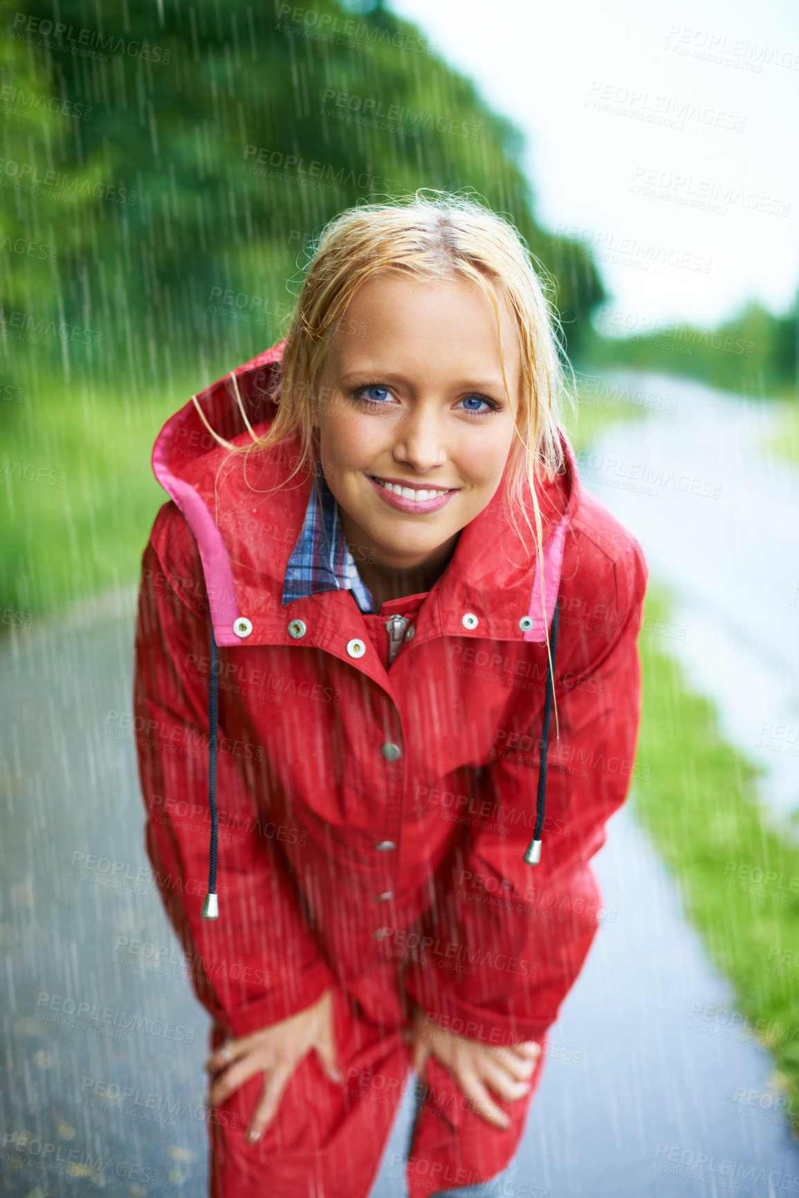 Buy stock photo Smile, portrait and young woman in the rain with coat in nature, road or street for winter. Happy, positive attitude and female person from Australia in drizzle or storm weather in outdoor forest.