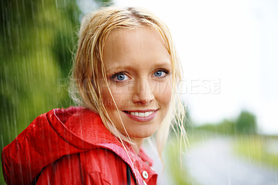 Buy stock photo Gorgeous young blonde woman wearing a red raincoat in the                                                                                                                                                                                                                                                                                            rain outdoors on a country road