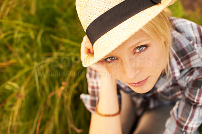 Buy stock photo Nature, portrait and young woman with straw hat sitting in an outdoor garden for fresh air. Serious, fashion and female person from Australia in the forest, woods or field with casual style.