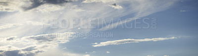 Buy stock photo Light clouds in a calm blue sky with copy space background. A beautiful clear summer sky with sunshine and a white soft textured cloudscape in nature. relaxing skies clearing up on a sunny day