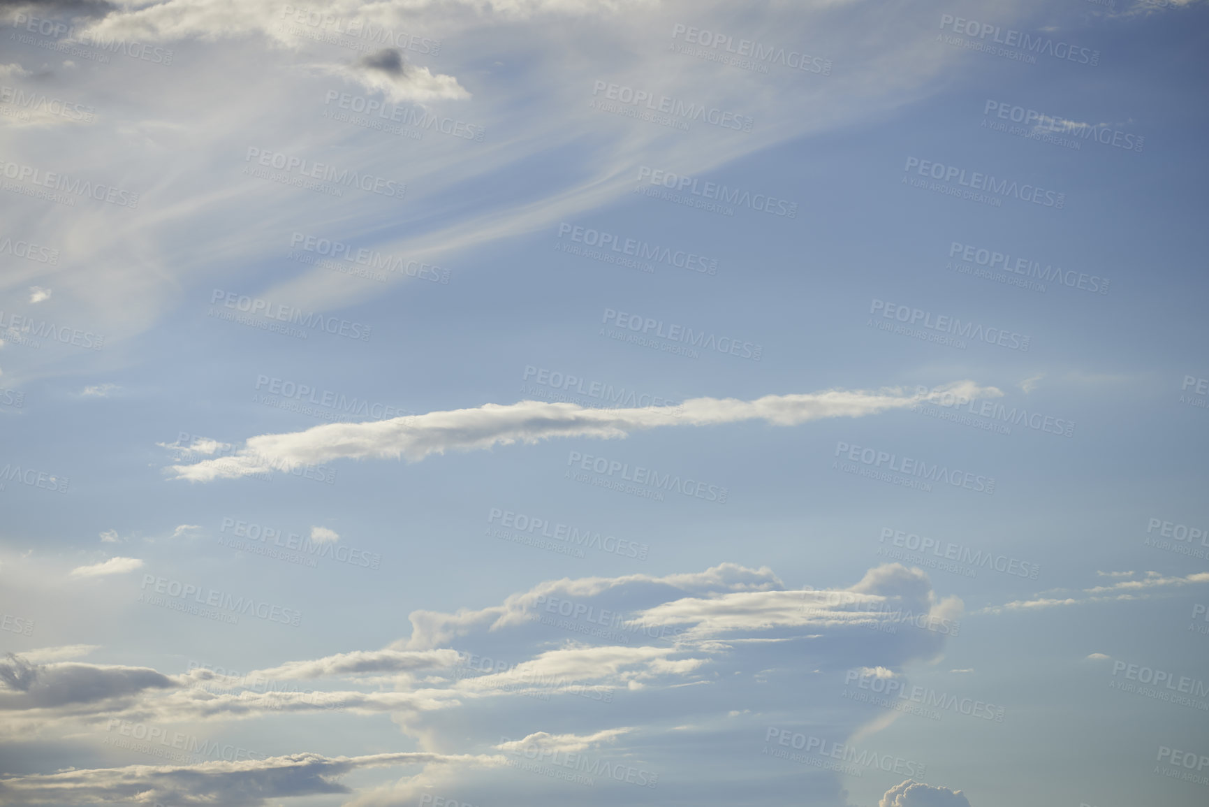 Buy stock photo Light clouds in a blue sky with copy space background. A beautiful clear summer sky with sunshine and a white soft textured cloudscape in nature. Calming skies clearing up on a sunny day