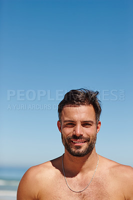 Buy stock photo Shot of a young man enjoying a day at the beach