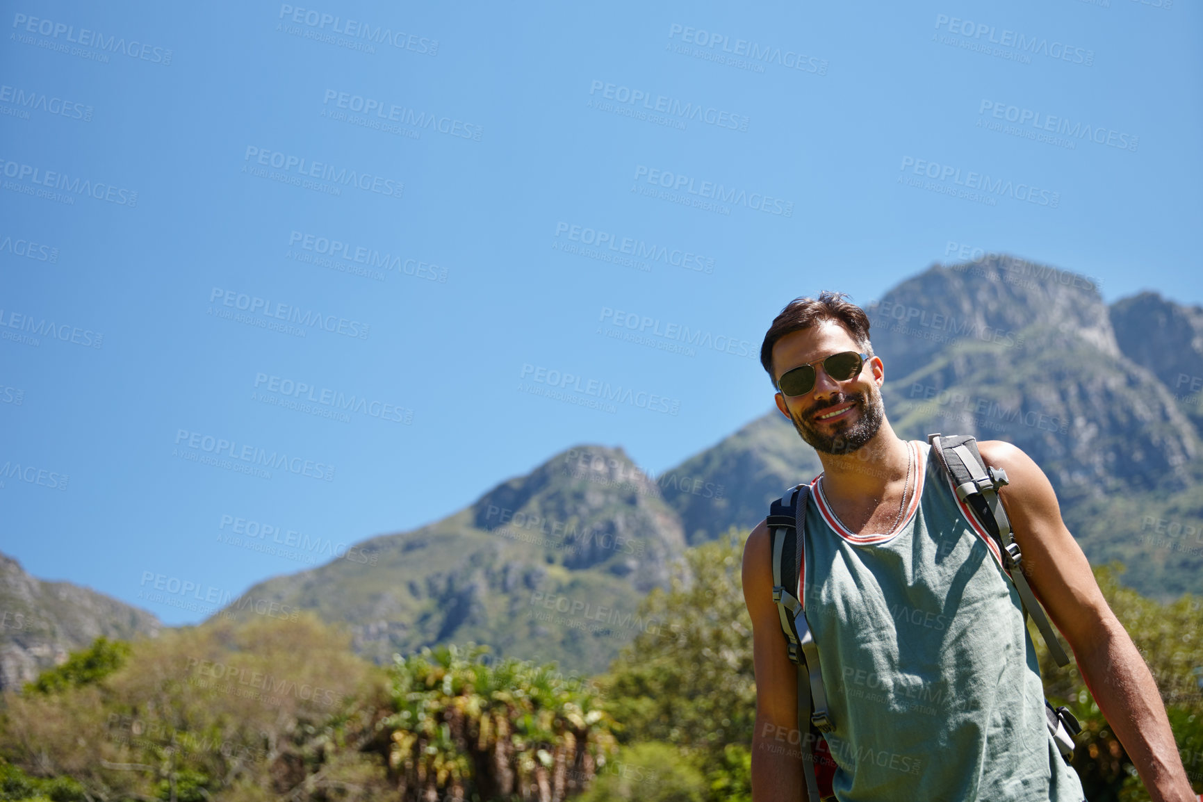 Buy stock photo Hiking, portrait and travel with man in mountains for adventure, journey or wilderness trekking. Exercise, hobby and wellness with happy hiker person outdoor in nature for fitness or exploration