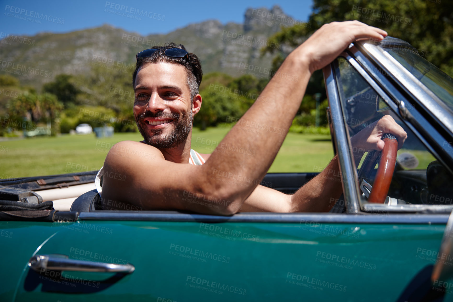 Buy stock photo Shot of a handsome young man on a roadtrip