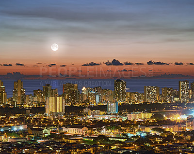 Buy stock photo A photo of the moon over Honolulu, Hawaii