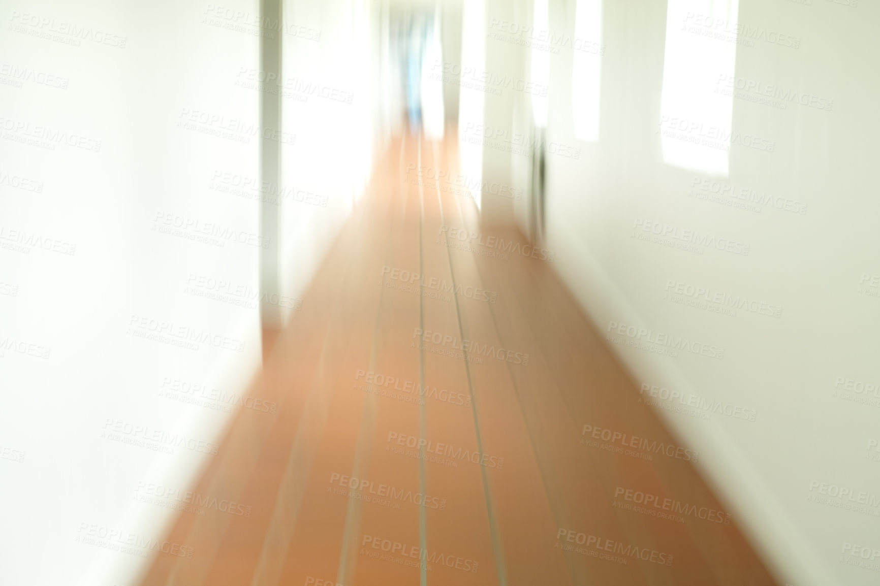 Buy stock photo A blurry tiled hallway with white walls and sun shining through the open windows. An empty hospital, clinic or school corridor