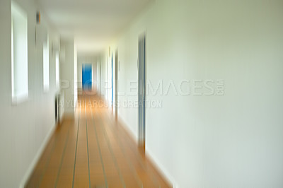 Buy stock photo Long, hallway and window with motion blur in interior for walkway, horizontal and door at end for enter to classroom or room. Hospital, school and empty corridor with architecture, narrow and passage