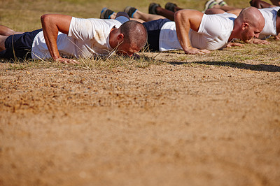 Buy stock photo Men, outdoor and push ups in bootcamp for fitness, exercise or military challenge with mockup. Soldiers, space or people in physical activity for workout, training or strength assessment for survival