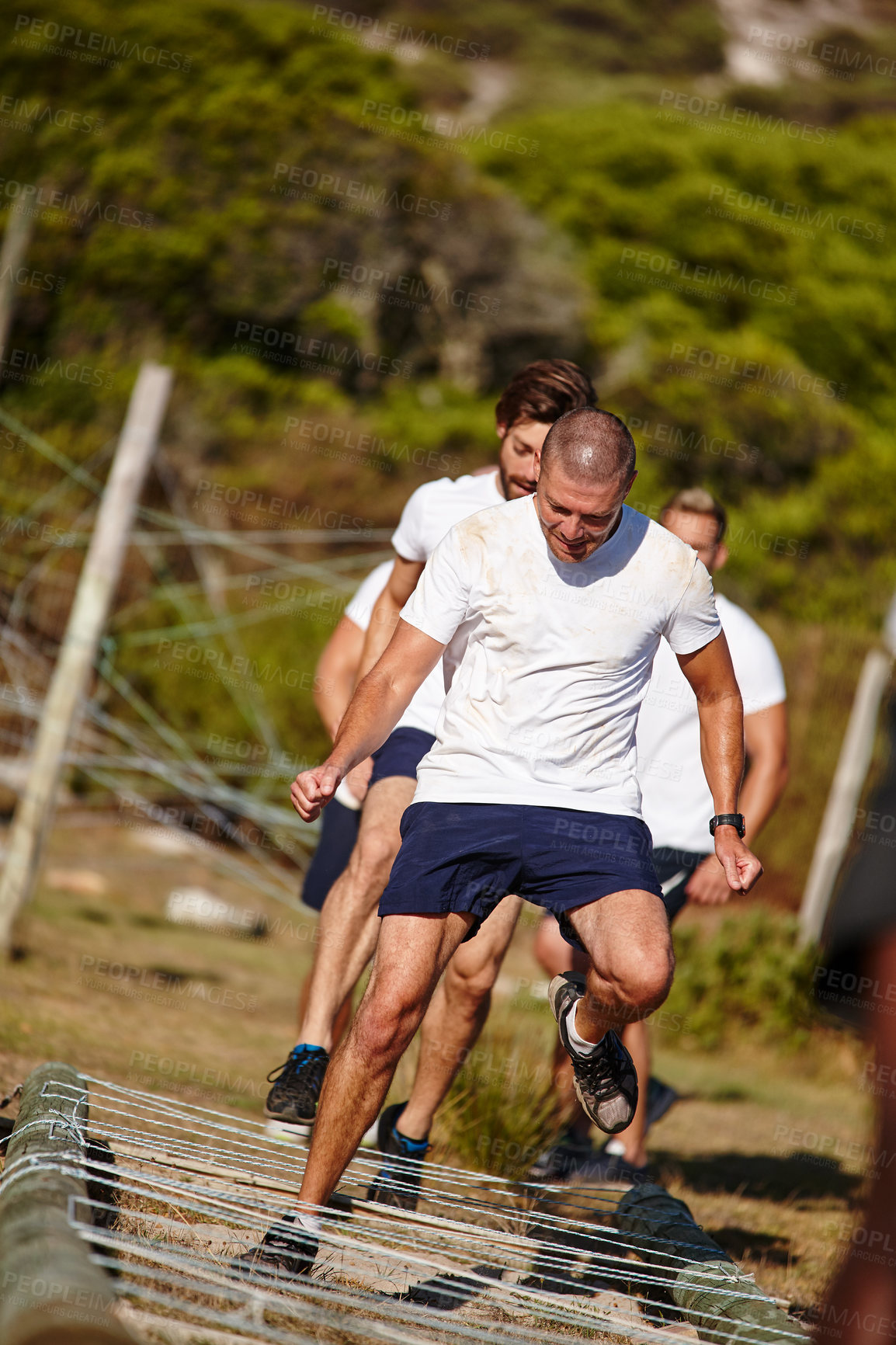 Buy stock photo Shot of a group of men doing drills at a military bootcamp