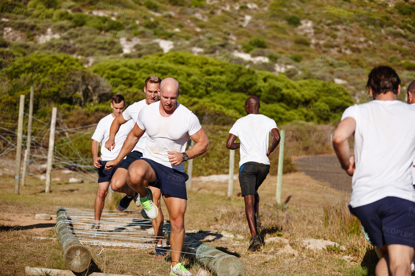 Buy stock photo Shot of a group of men doing drills at a military bootcamp