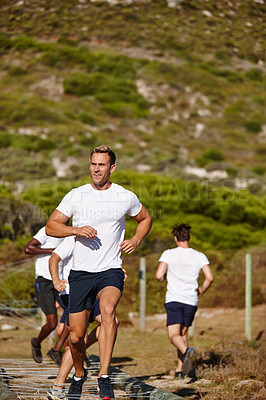 Buy stock photo Shot of a group of men doing drills at a military bootcamp